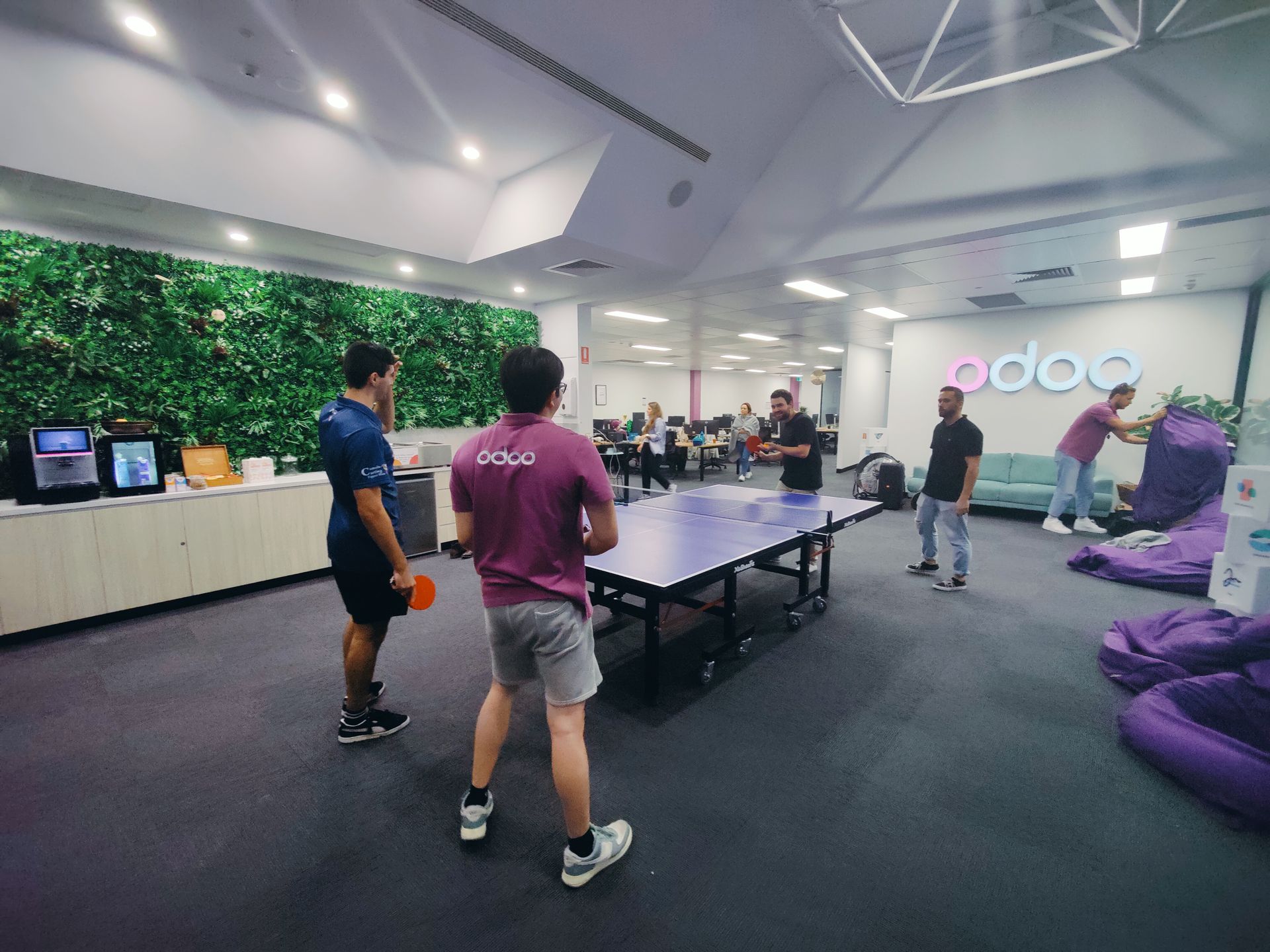 four men playing table tennis